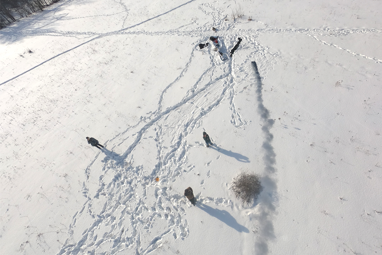 artists Lisa Hirmer and Andrew Maize experiment with kites and smoke bombs in a winter landscape