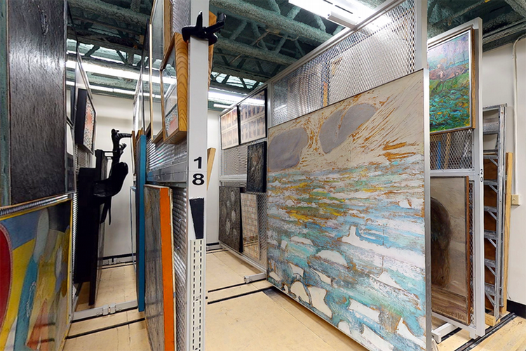 An image looking at racks of artwork in McIntosh Gallery's collection vault.